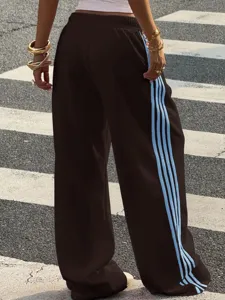 Casual wide-leg sweatpants with side stripe design, comfortable loose fit urban streetwear style for women.