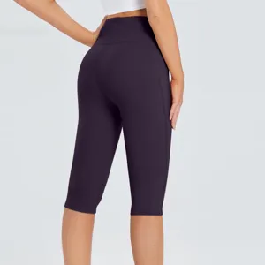 High waist capri yoga pants with side pockets, solid dark purple athletic leggings.