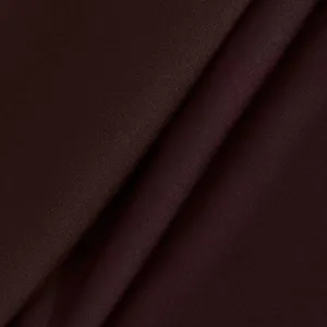 Close-up detail of dark brown women's stretch yoga pants fabric, soft and high elastic.