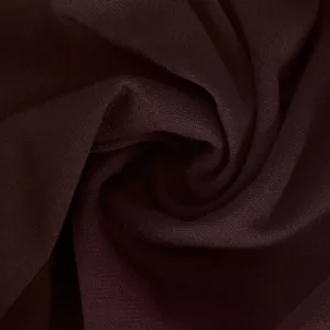 Close-up detail of dark brown stretchy fabric showing fine texture and soft folds.