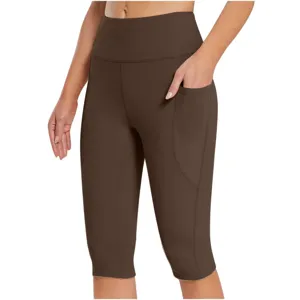 Detail view of women high waist brown pocket yoga capris, soft workout fitness leggings.