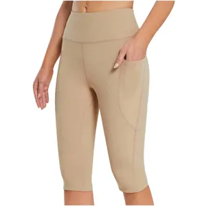 High-waisted women's yoga capri leggings with side pockets in camel for fitness sports.
