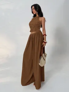 Detailed view of the brown pleated halter top and wide leg pants set, showing texture.