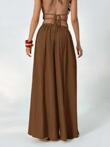 Detailed back view of brown pleated high waist wide leg pants with elegant drape