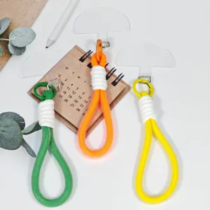 Colorful woven phone lanyard wrist strap with transparent tether patch for daily use.