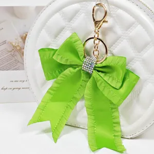 Green ribbon bow bag charm with sparkling rhinestones and gold keychain for women accessories.