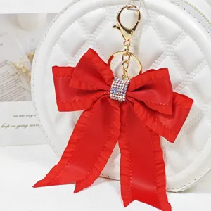Red ribbon bow bag charm keychain with sparkling rhinestones for stylish bag pendant decor