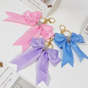 Colorful pleated ribbon bow keychain with shiny rhinestones, sweet bag pendant charm style.