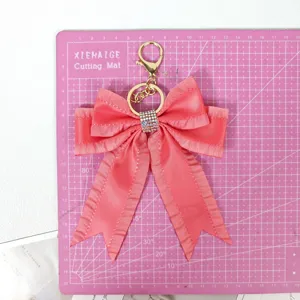 Elegant ribbon bow keychain with sparkling rhinestones, perfect charming bag pendant accessory.
