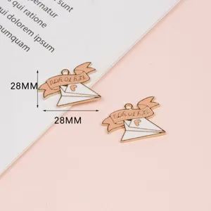 Close up of exquisite alloy envelope pendant charms featuring cute ribbon design for DIY jewelry.