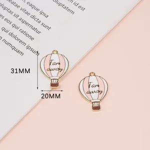 Detailed close-up of pink and white enamel hot air balloon alloy DIY jewelry charms.