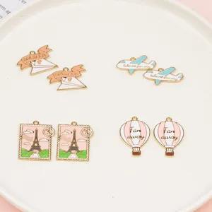 DIY alloy charms details showing travel theme airplane hot air balloon Eiffel tower pendants.