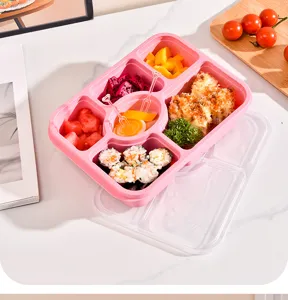 Detail view of the pink wheat straw six-compartment bento box showcasing food separation and lid.