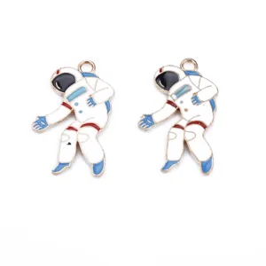 Close-up detail shot of cute astronaut alloy enamel pendant charms for DIY jewelry making.