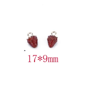 Detailed closeup of red strawberry alloy DIY charm pendant, high quality metal craft accessory.