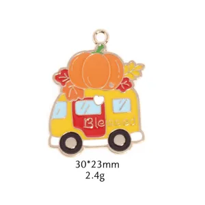 Detailed shot of an autumn pumpkin camper van enamel metal charm pendant accessory.