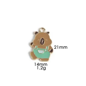 Detailed view of the cute capybara enamel pendant in green overalls, metal alloy charm.