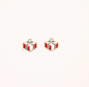 Close-up detail of Christmas gift box enamel charms, alloy DIY jewelry accessories for crafts.