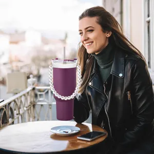 Purple insulated tumbler detail featuring elegant pearl chain strap in outdoor lifestyle scene.