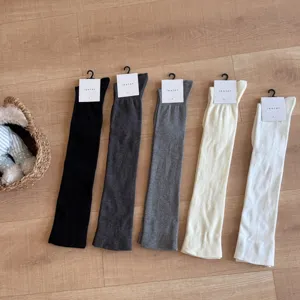 Detailed view of women's over-the-knee knit socks in multiple colors laid out neatly.