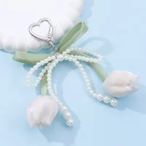 Cute pearl bow tulip bag charm and phone pendant, sweet ins style DIY hanging accessory.