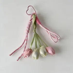 Cute tulip keychain detail shot showing pink and green fabric flower charms with heart clasp.
