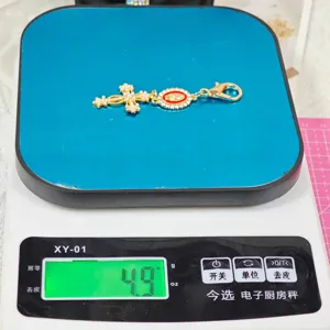 Alloy rhinestone cross and religious medal charm keyring detail shot, lightweight 4.9g accessory.