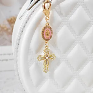 Gold alloy rhinestone cross keychain bag charm with pink medallion, stylish religious accessory.