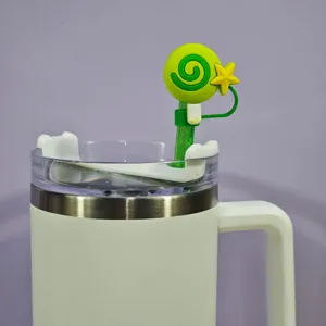 Detailed shot of cute green lollipop straw cover with star, reusable silicone dust cap accessory.