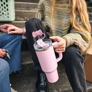 Bling rhinestone bow straw topper and pink insulated tumbler cup for daily use and party decor.