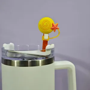Silicone straw topper detail showing cute yellow lollipop and star design on a white cup.