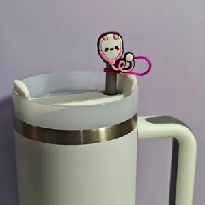 Close-up detail of a cute pink medical stethoscope silicone straw cover accessory on a tumbler.