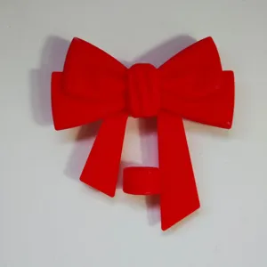 Red silicone bow straw topper detail shot, dust plug accessory for 10mm tumbler straws.