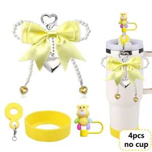 Detailed view of the 4pcs yellow pearl bow keychain and cute bear straw cap for tumbler cups.