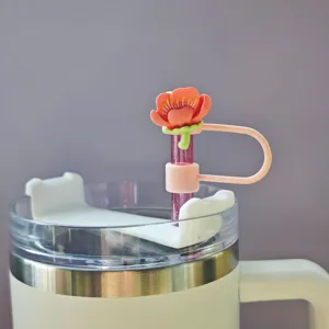 Close-up detail of the cute pink flower silicone straw cover and dust cap accessory.