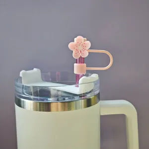 Close-up of pink cherry blossom silicone straw cover, 10mm dust plug accessory detail.