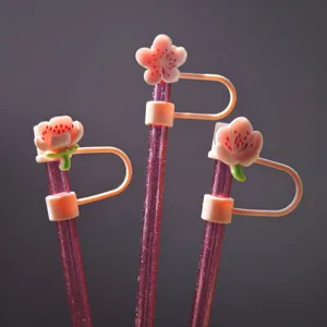 Detailed view of pink glitter cherry blossom straw covers, cute 10mm dust plug cup accessories.