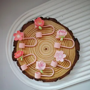 Detailed view of cute pink cherry blossom silicone straw cover for 10mm cup accessories cap.
