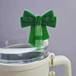 Green silicone bow straw topper for 10mm tumblers, cute dust-proof straw cover accessory.