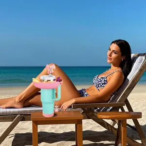Stanley 40oz tumbler snack bowl with bow straw topper and cup chain for beach outdoor use.