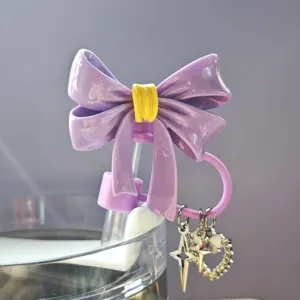 Purple resin bow straw topper detail with cute star and heart charms, dust cover.