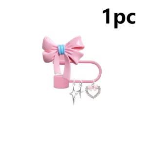 Pink bow straw cover detail shot, resin dust plug with cute charms and safety pin design.