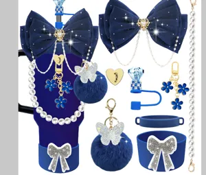 Detailed view of blue Stanley cup accessories set including bow, pearl chain and pom pom.