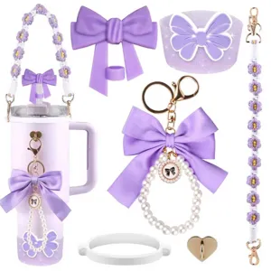 Purple tumbler accessories detail view, cute silicone bow and crochet flower keychain pendant set.