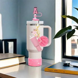 Pink mini tumbler keychain set with letter straw cover, plush ball and silicone boot.