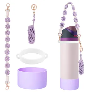 Handmade macrame water bottle strap set with silicone boot and flower charms detail view