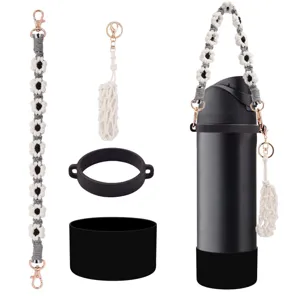 Handmade macrame daisy water bottle strap, mini net pouch, and black silicone boot set.