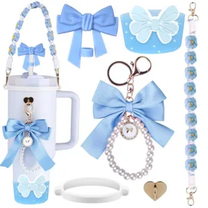 Detailed view of cute light blue tumbler accessories, bow charms, and daisy braided straps.