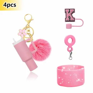 Pink tumbler charm keychain set with pompom, letter straw cover and glitter silicone boot.