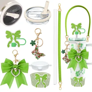 Detailed view of green bow tumbler accessory set with silicone strap, straw cover & cute cup sleeve.